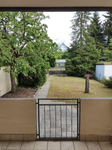 a gate to a yard with a park at Vogelnest - Wohlfühlen im Grünen in Karlsruhe