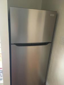 a stainless steel refrigerator in a kitchen at 1BR Historic Art Deco Charm Meets Modern Comfort- Huge Tropical Garden in Posh Coral Gables-10 min Airport in Miami