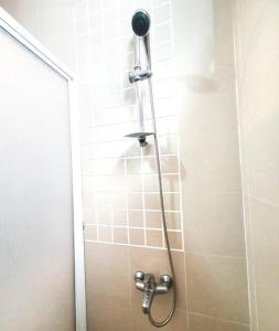 a shower with a shower head in a bathroom at [HERITAGE 4] HOMESTAY Studio 4Pax, FREE WIFI in Seri Kembangan