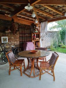 a patio with a table and chairs and a bike at La roulotte des Carpates in Gaillac