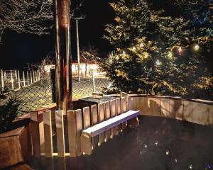 a bench in a park at night with a tree at Pensiunea Cocoș in Spulber +34 photos