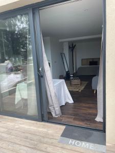 a sliding glass door of a home with a living room at Charmante Propriété Arborée in Borgo