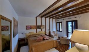 a bedroom with a bed and a lamp in a room at Is Benas Country Lodge in San Vero Milis