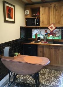 a kitchen with a wooden table and a counter at Farmhouse Gite in Saint-Georges
