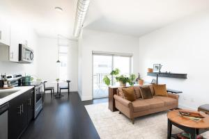 a kitchen and living room with a couch and a table at Flexhome Skywalk to Fiserv 1BR Apt U6 - READ INFO in Milwaukee