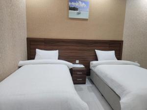 Ένα ή περισσότερα κρεβάτια σε δωμάτιο στο Summit Hotel Suites - القمة للأجنحة الفندقيه