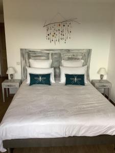 a bedroom with a large bed with blue and white pillows at Les Etoiles de Calès in Calès