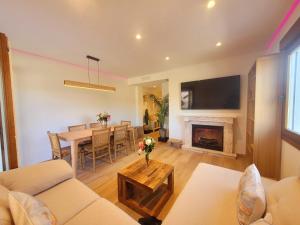 a living room with a table and a fireplace at Relaxing Time in Candeleda