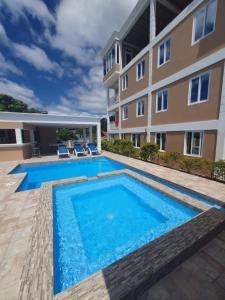 an image of a swimming pool in front of a building at 2 minutes from Roseau, Cozy studio with shared pool in Roseau