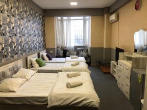 um quarto com quatro camas e um lavatório em Museum Hostel em Tbilisi