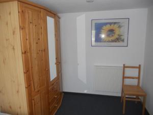 a room with a wooden door and a wooden chair at Ferienhaus Vorwachs 1 in Schwielochsee