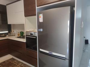 a stainless steel refrigerator in a kitchen at Golden House in Ramallah
