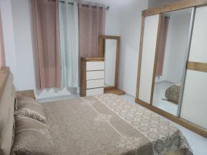 a bedroom with a bed and a large mirror at Golden House in Ramallah