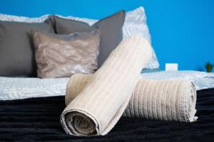 a rolled up sock sitting on a bed at AppartCosy-StQuentin in Saint-Quentin