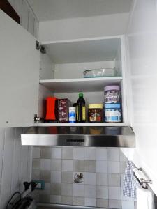 a kitchen shelf with food items sitting on it at Pian del Falco in Sestola