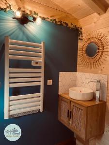 a bathroom with a sink and a mirror on the wall at Little Wood Lodges in Bailly-aux-Forges +72 photos