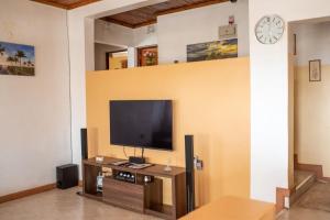 a living room with a flat screen tv on a wall at Augustine Cosy Homes in Nakuru