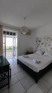 a bedroom with a large bed with towels on it at Nikolas Villa in Ambelas