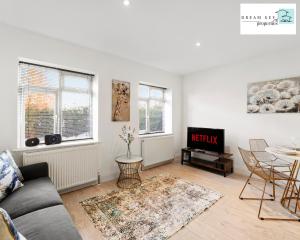 a living room with a couch and a table at Spacious Two Bedroom Apartment by Dream Key Properties Short Lets & Long Lets Uxbridge- 1 in Uxbridge