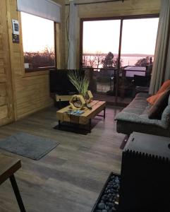 a living room with a couch and a coffee table at Vistaranco Costanera in Lago Ranco