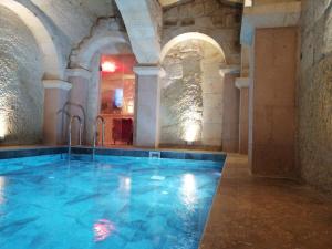 a large swimming pool in a large building at Solo Cave Suites in Nevşehir