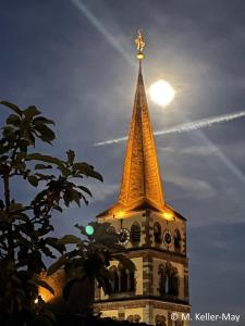 a steeple of a building with the moon in the sky at Apartment Magnolia in Karlstadt