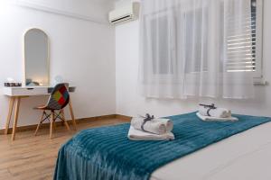 a bedroom with a bed with two towels on it at Blue Mile Apartman Split in Split