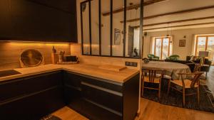 a kitchen with a sink and a dining room at Chalet Peak Noir entier 12pers - Cosy House Peak Noir for 12people in Le Monêtier-les-Bains