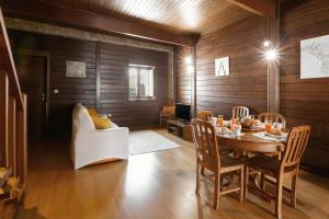 a dining room with a table and a couch at Stylish Rustic Villa in Vau