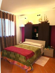 a bedroom with a bed with a red blanket on it at A CASA DI TERE in Medicina