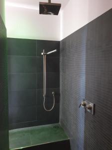 a bathroom with a shower with a green tub at A CASA DI TERE in Medicina +10 photos