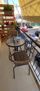 a table and a chair on a balcony at Beautiful Choice - near Athens airport - 50m from the sea - IQ+ in Artemida
