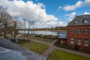 an aerial view of a brick building and a lake at Lotsenstation am Nord Ostsee Kanal in Schülp