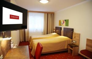 מיטה או מיטות בחדר ב-Tinschert Hotel-Restaurant-Partyservice