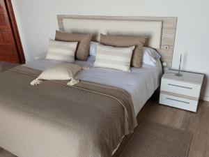 una camera da letto con un letto grande con due cuscini di Casita Los Celajes a La Guancha