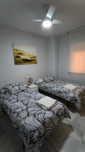a room with two beds in a room at Apartamentos La Casa de Bebita in Fuengirola