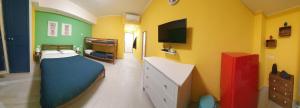 a room with a bedroom with a bed and a tv at Sicilia Bedda Taormina in Taormina