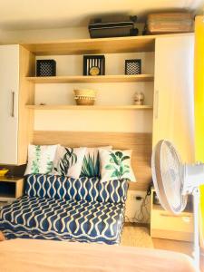 a living room with a couch and a fan at CasaMia Studio Sanremo Oasis Cebu in Talisay +31 photos