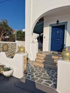 een voordeur van een huis met een blauwe deur bij Voula's Apartment in Elafonisos