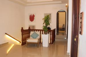 a hallway with a chair and a potted plant at Hotel Casa Agustina in Cartagena de Indias
