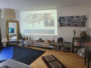 a living room with a large poster on the wall at 1 Zimmer App in Köln Ehrenfeld in Cologne