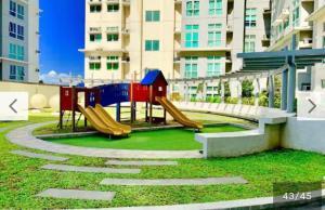 a playground with a slide in front of a building at San Lorenzo place condo in Manila