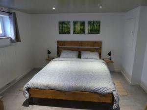 a bedroom with a bed with two pillows on it at La tanière des oursons in Aywaille