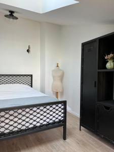 a bedroom with a black bed and a dresser at Modern country house near Fontainebleau in Samoreau