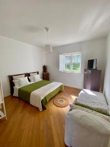 a bedroom with two beds and a television in it at Agriturismo Colle Igino in Matera