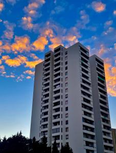 a tall white building with a cloudy sky in the background at B&B Baldari2.0 in Taranto