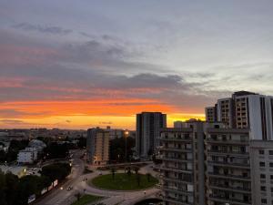 a sunset in a city with tall buildings at B&B Baldari2.0 in Taranto