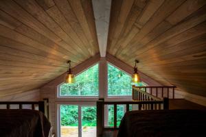 a room with a large window in a log cabin at Villa Pillapalu in Pillapalu