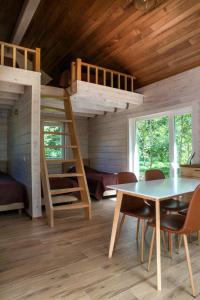 a bedroom with a bunk bed and a table and chairs at Villa Pillapalu in Pillapalu