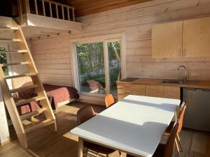 a kitchen with a table and a ladder in a room at Villa Pillapalu in Pillapalu